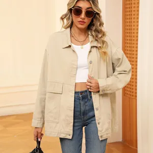 Detailed view of women's vintage beige denim jacket with oversized pockets