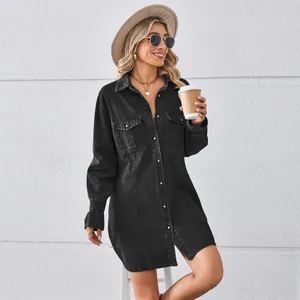 Full-body view of a stylish black denim shirt dress paired with a chic hat and glasses