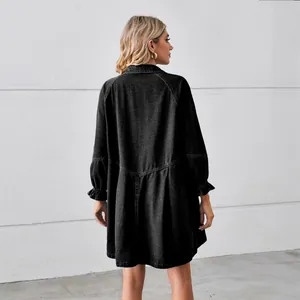 Back view of a loose black washed denim midi dress featuring ruffled long sleeves and casual fit