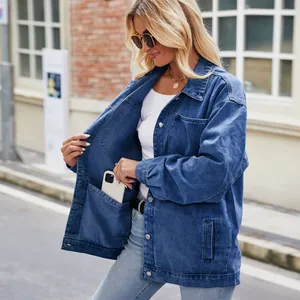 Detail of oversized denim jacket showing a functional large inner pocket for phone