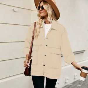 Detailed street style look of a beige oversized vintage denim jacket for women.