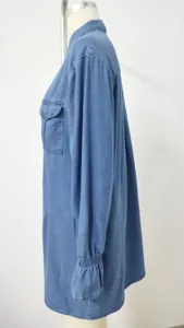 Detailed side view of loose washed blue denim dress featuring ruffled elasticated cuffs