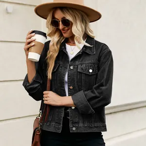 Close-up of a women's washed black slim fit cropped denim jacket with metal buttons