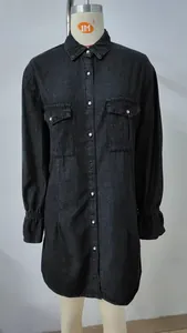 Detailed view of a washed black denim shirt dress featuring dual chest pockets and collar.