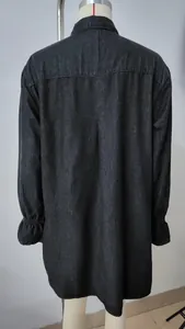 Detailed back view of a loose washed denim midi dress featuring elegant ruffled cuffs