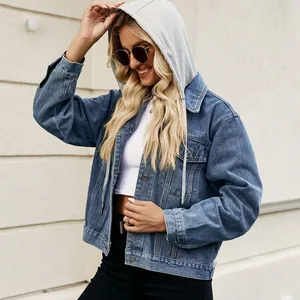 Detailed view of women's washed blue denim jacket featuring a grey cotton drawstring hood