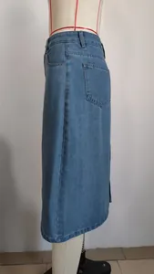 Side view detail of a washed blue denim midi skirt on a white tailor mannequin