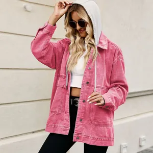 Stylish pink oversized denim jacket with grey hood for a fashionable layered casual look.