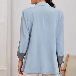 Dettaglio vista posteriore del blazer azzurro con fodera a righe elegante sui polsini.