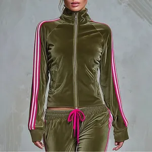 Close-up detail of women's olive green velvet tracksuit set with pink and white side stripes