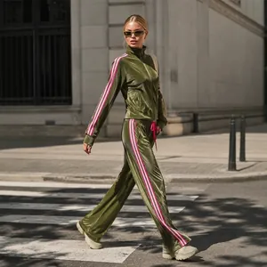 Chic olive green velvet tracksuit for women featuring side stripes and high-neck jacket