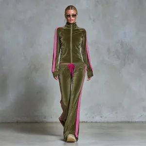 Full-length view of a women's olive green velour tracksuit with pink side stripes