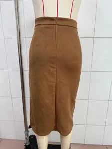 Macro view showing the back zipper detail and texture of a brown faux suede midi skirt