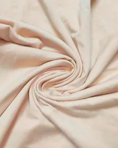 Close-up of soft pink jersey fabric showing delicate texture and drape for summer dress