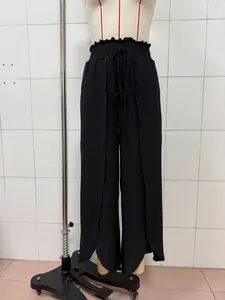 Front view of black wide-leg trousers with elegant side slits on mannequin