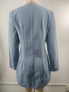 Detailed back view of a light blue washed denim mini dress with long sleeves and waisted design