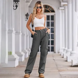 Outdoor lifestyle view of women's dark gray washed denim cargo pants with pockets