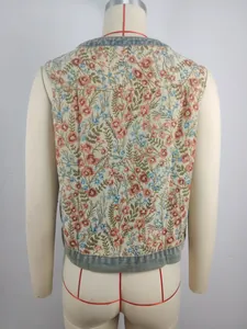 Detailed rear view of vintage floral jacquard cropped sleeveless vest with denim trim.