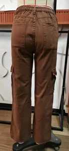 Rear view of brown washed denim cargo pants with half-elastic waist on a mannequin