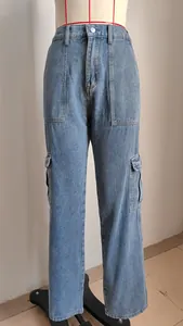 Close-up view of light wash denim cargo pants with side flap pockets and high waist design