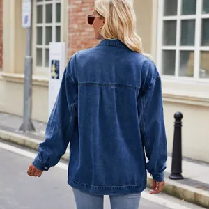 Close-up back view of a vintage washed blue denim jacket with a loose fit design.