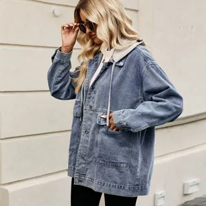 Casual loose-fit women's denim jacket with grey hood shown in a stylish side view profile