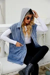 A detailed view showing the texture of a casual blue denim vest with a grey hood