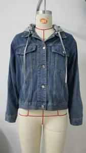 Front view detail of a stylish slim-fit blue washed denim jacket featuring a grey hood