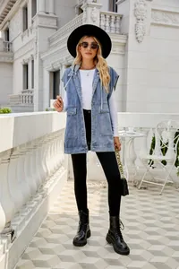 Stylish women's sleeveless denim vest with hood worn on an outdoor terrace.