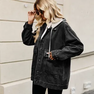 Close-up side view of a classic black oversized denim jacket with integrated grey hood