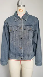 Front view of a classic slim-fit washed blue denim jacket featuring chest pockets