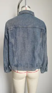 Detailed back view of a classic slim fit washed blue denim jacket for women on mannequin