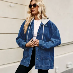 Detail of women's oversized blue denim jacket with grey contrast drawstring hood.