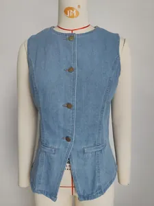 Close-up detail of a light blue denim sleeveless vest with vintage buttons on a mannequin