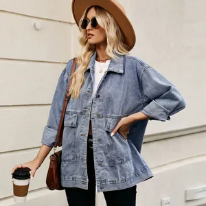 Classic loose denim jacket styled with a brown hat and bag for a retro casual look.