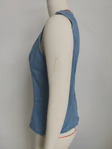 Detailed side view of a stylish washed blue denim sleeveless vest on a mannequin.