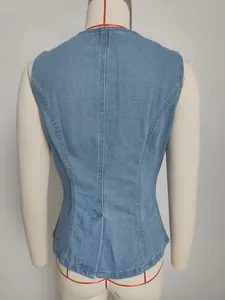 Detailed back view of a tailored light wash denim vest with vertical seam construction