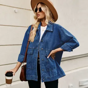 Close-up of oversized blue denim jacket showing button details and large patch pockets
