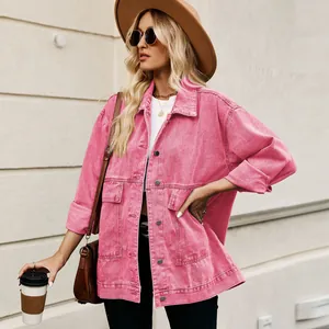 Detailed view of stylish bright pink oversized denim jacket featuring large front pockets