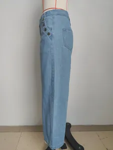 Detailed side view of stylish light blue high-waisted denim pants with button accents.