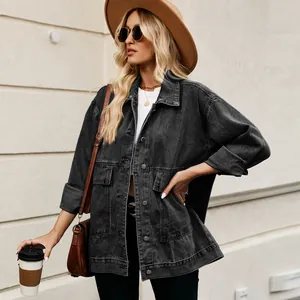 Model in a vintage loose black denim jacket with a brown hat and crossbody bag