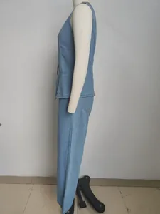 Side view of stylish women's two-piece washed denim sleeveless vest and long pants set on mannequin