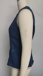 Side view detail of a fashionable dark blue washed denim sleeveless vest on a mannequin.