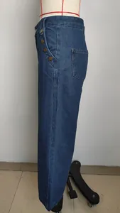 Side detail of stylish high-waisted washed blue denim pants shown on a mannequin