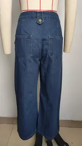 Back view detail of high-waisted blue denim wide-leg pants on mannequin