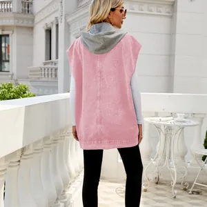 Back view of a stylish women's pink hooded denim vest presented in a casual outdoor setting