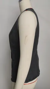 Side view detail of a dark washed denim sleeveless vest shown on a professional mannequin