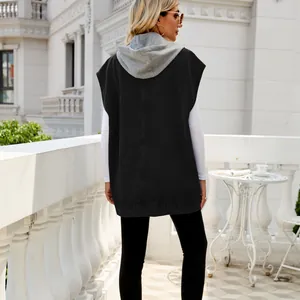 Back view of a stylish black hooded denim vest sleeveless jacket for women on a balcony