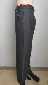 Detailed side view of washed charcoal gray denim wide leg pants displayed on a mannequin