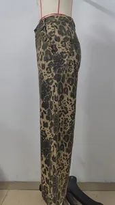 Close-up side view showing the leopard print pattern and button details of denim trousers